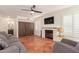 Living room with fireplace, gray sofa and built-in storage at 1571 W Orchid Ln, Chandler, AZ 85224