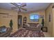 Cozy living room with stone fireplace and comfy seating at 16149 E Thistle Dr, Fountain Hills, AZ 85268