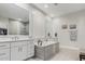 Elegant bathroom with soaking tub and dual vanities at 18373 W Sells Dr, Goodyear, AZ 85395
