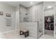 Modern bathroom with a large walk-in shower and bench at 18373 W Sells Dr, Goodyear, AZ 85395