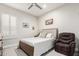 Spacious bedroom with a comfortable bed and recliner at 18373 W Sells Dr, Goodyear, AZ 85395