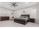 Main bedroom with a large bed, dresser, and ceiling fan at 18373 W Sells Dr, Goodyear, AZ 85395