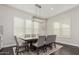 Bright dining room featuring a wood table, gray chairs, and plantation shutters at 18373 W Sells Dr, Goodyear, AZ 85395