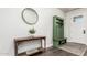 Entryway featuring green bench, console table and mirror at 18373 W Sells Dr, Goodyear, AZ 85395