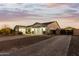 Two-car garage with a gated driveway and landscaping at 18373 W Sells Dr, Goodyear, AZ 85395