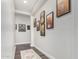 Light and airy hallway with framed photos and a runner at 18373 W Sells Dr, Goodyear, AZ 85395