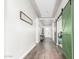 Long hallway with green doors and wood flooring at 18373 W Sells Dr, Goodyear, AZ 85395