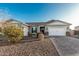 House exterior with two-car garage and landscaping at 18373 W Sells Dr, Goodyear, AZ 85395