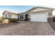 House exterior with a two-car garage and landscaping at 18373 W Sells Dr, Goodyear, AZ 85395