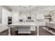 Bright kitchen with white cabinets, an island, and stylish light fixtures at 18373 W Sells Dr, Goodyear, AZ 85395
