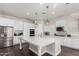 Spacious kitchen featuring white cabinets, large island, and stainless steel appliances at 18373 W Sells Dr, Goodyear, AZ 85395