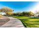 Curving concrete pathway winds through a neighborhood park at 18373 W Sells Dr, Goodyear, AZ 85395