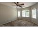 Spacious bedroom with large windows and carpeted floors at 21129 N Grantham Rd, Maricopa, AZ 85138