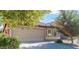 House exterior featuring a two-car garage and landscaping at 21129 N Grantham Rd, Maricopa, AZ 85138