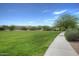 Wide grassy area with walking path at 21129 N Grantham Rd, Maricopa, AZ 85138