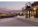 Spiral staircase leads to a large backyard patio at sunset at 23523 N 79Th Ave, Peoria, AZ 85383