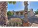 Backyard view featuring a large palm tree and desert plants at 2394 E Fiesta Dr, Casa Grande, AZ 85194