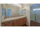 Bathroom with double sinks, wood cabinets, and a separate shower at 2394 E Fiesta Dr, Casa Grande, AZ 85194
