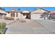Single-story house with a two-car garage and desert landscaping at 2394 E Fiesta Dr, Casa Grande, AZ 85194