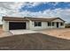 New construction home, featuring a two-car garage and neutral exterior at 25627 W Hedgehog Rd, Wittmann, AZ 85361