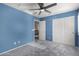 Blue-walled bedroom with ceiling fan, double doors and window shutters at 30384 N 128Th Ln, Peoria, AZ 85383