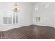 Bright dining room with dark hardwood floors and a chandelier at 30384 N 128Th Ln, Peoria, AZ 85383