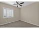 Bright bedroom with ceiling fan and window shutters at 40718 N Copper Basin Trl, Phoenix, AZ 85086