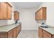 Bright laundry room with ample cabinet space and a utility sink at 40718 N Copper Basin Trl, Phoenix, AZ 85086