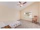 Cozy bedroom with a ceiling fan, large window, and rocking chair at 409 Leisure World --, Mesa, AZ 85206