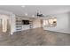 Open living area with wood-look tile floors and built-in shelving at 4210 W Palace Station Rd, New River, AZ 85087