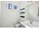 Clean bathroom with floating shelves, a gray vanity, and a modern toilet at 4444 N 25Th St # 15, Phoenix, AZ 85016