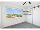 Bright bedroom with city views, built-in shelves, and modern sliding door at 4444 N 25Th St # 15, Phoenix, AZ 85016