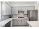 Modern kitchen with gray cabinets, quartz countertops, and stainless steel appliances at 4444 N 25Th St # 15, Phoenix, AZ 85016