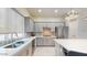 Modern kitchen with gray cabinets, quartz countertops, and stainless steel appliances at 4444 N 25Th St # 15, Phoenix, AZ 85016