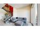 Modern living room featuring a gray sectional sofa and a stylish staircase at 4444 N 25Th St # 15, Phoenix, AZ 85016