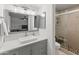 Modern bathroom with gray vanity, white sink, and walk-in shower at 5111 S Clark Dr, Tempe, AZ 85282