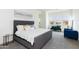 Spacious bedroom with gray upholstered bed, large windows, and sitting area at 562 N Sun Rd, Apache Junction, AZ 85119