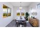 Bright dining room features a wood table and sideboard with large windows at 562 N Sun Rd, Apache Junction, AZ 85119