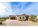 Single-story home with a terracotta tile roof and landscaped front yard at 562 N Sun Rd, Apache Junction, AZ 85119