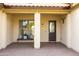 Covered entryway with a dark brown door and a bench at 562 N Sun Rd, Apache Junction, AZ 85119