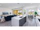 Open concept kitchen features modern island, stainless steel appliances, and breakfast nook at 562 N Sun Rd, Apache Junction, AZ 85119