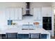 Modern kitchen features white shaker cabinets, a marble island and high end appliances at 562 N Sun Rd, Apache Junction, AZ 85119