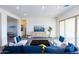 Bright living room featuring a blue sofa and a sleek media console at 562 N Sun Rd, Apache Junction, AZ 85119