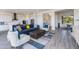 Open concept living area with a blue sofa, and a view into the kitchen at 562 N Sun Rd, Apache Junction, AZ 85119