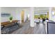 Open living space with gray tile floors, a navy sofa, and kitchen views at 562 N Sun Rd, Apache Junction, AZ 85119