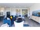 Open living area with blue sofa, large windows, and contemporary decor at 562 N Sun Rd, Apache Junction, AZ 85119