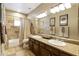 Bathroom with double vanity, bathtub, and shower at 8689 E Windrose Dr, Scottsdale, AZ 85260