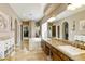 Primary bathroom with double vanity, soaking tub, and walk-in closet at 8689 E Windrose Dr, Scottsdale, AZ 85260
