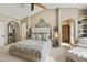 Main bedroom with large bed, tufted headboard, and ceiling fan at 8689 E Windrose Dr, Scottsdale, AZ 85260