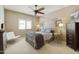 Bright bedroom with a metal canopy bed, dresser, and chair at 8689 E Windrose Dr, Scottsdale, AZ 85260